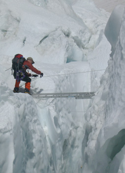 crossing a crevasse in the Khumbu icefall on Everest